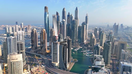 Aerial view of towering skyscrapers and business hubs in a UAE free zone, illustrating economic growth.